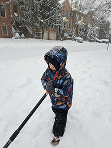 Andrew's son shoveling snow.